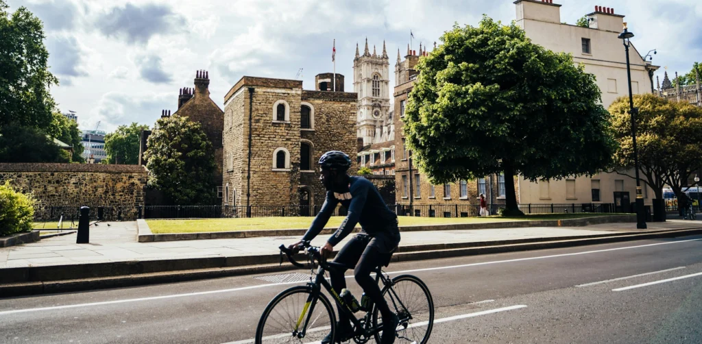 A picture of a cyclist riding their bike on a main road