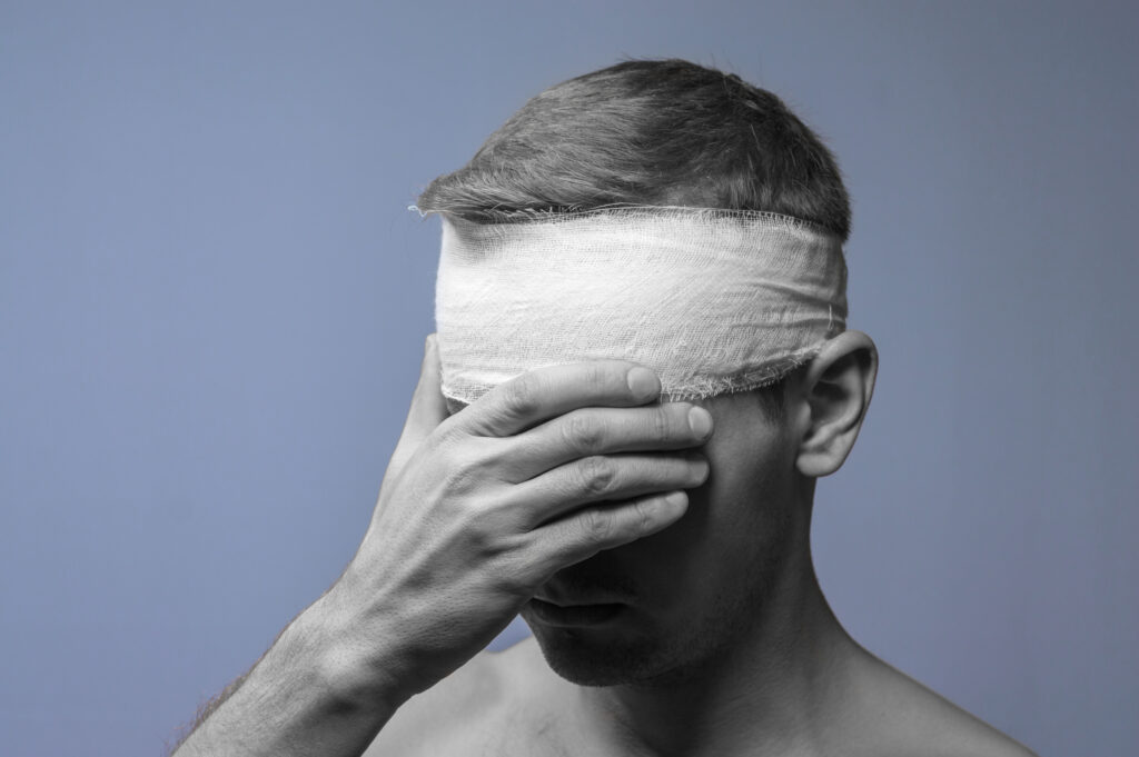 man with bandage on head